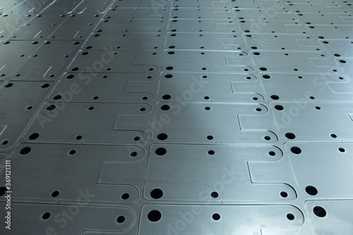 A metal sheet on which the products are cut out on a laser machine. Metalworking of metal at the plant.