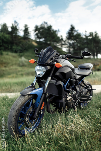 Photo of modern motorcycle on the country road.