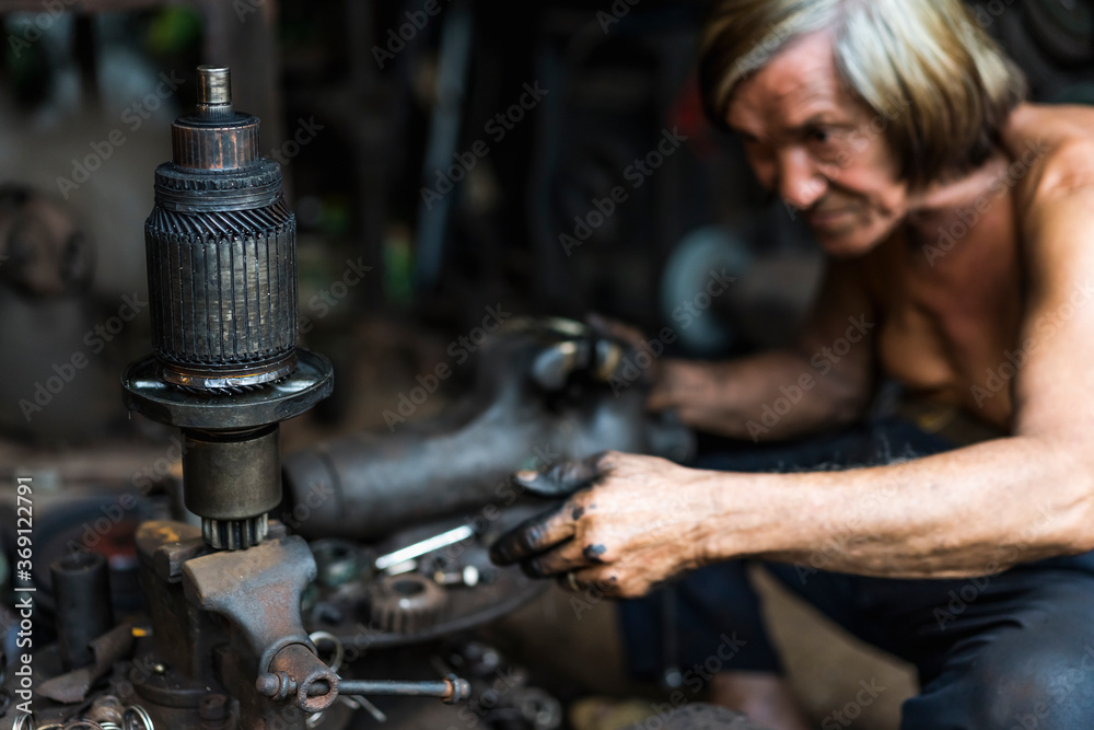 Man working in a mechanical workshop in Vietnam Man working in a mechanical workshop in Vietnam
