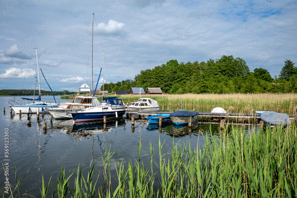 jetty with boats at Lake Krakow in the Mecklenburg Lake District, Germany