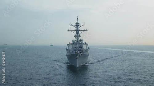Bow and front deck of guided missile destroyer on ride. Aerial frontal view as the warship ploughs through waters photo