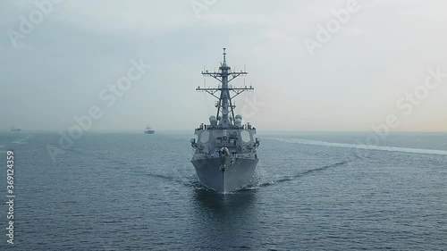 Bow and front deck of guided missile destroyer on ride. Aerial frontal view as the warship ploughs through waters