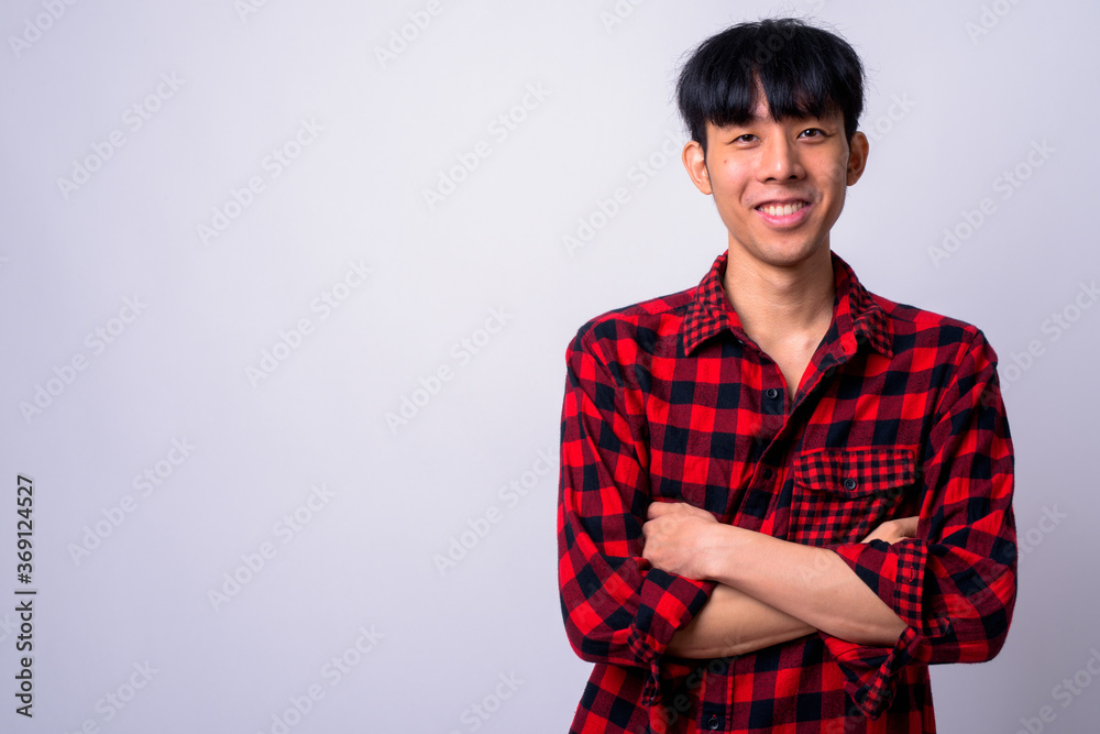 Portrait of happy young handsome Asian hipster man Portrait of happy young handsome Asian hipster man