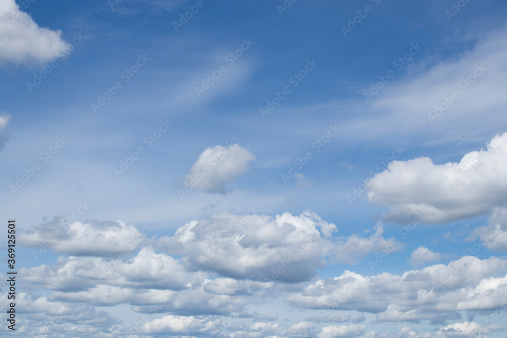 Obraz premium Cumulus clouds against a blue sky.