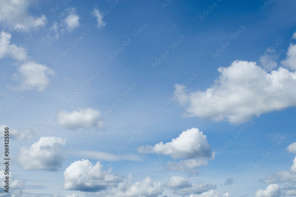 Obraz premium Cumulus clouds against a blue sky.