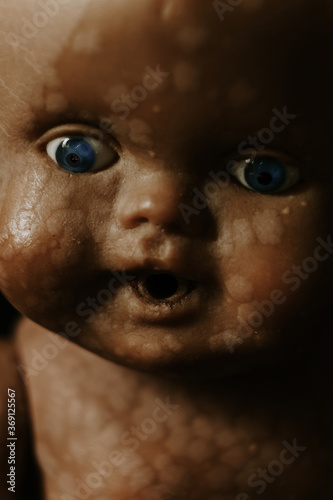 close up of a vintage baby doll, in the shadow