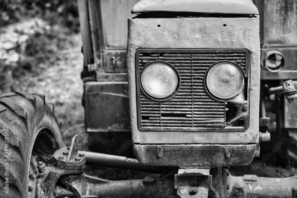 Old damaged tractor lights detail in black and white