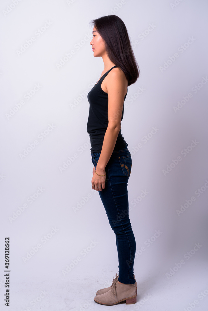 Full body shot profile view of young beautiful Asian woman Full body shot profile view of young beautiful Asian woman