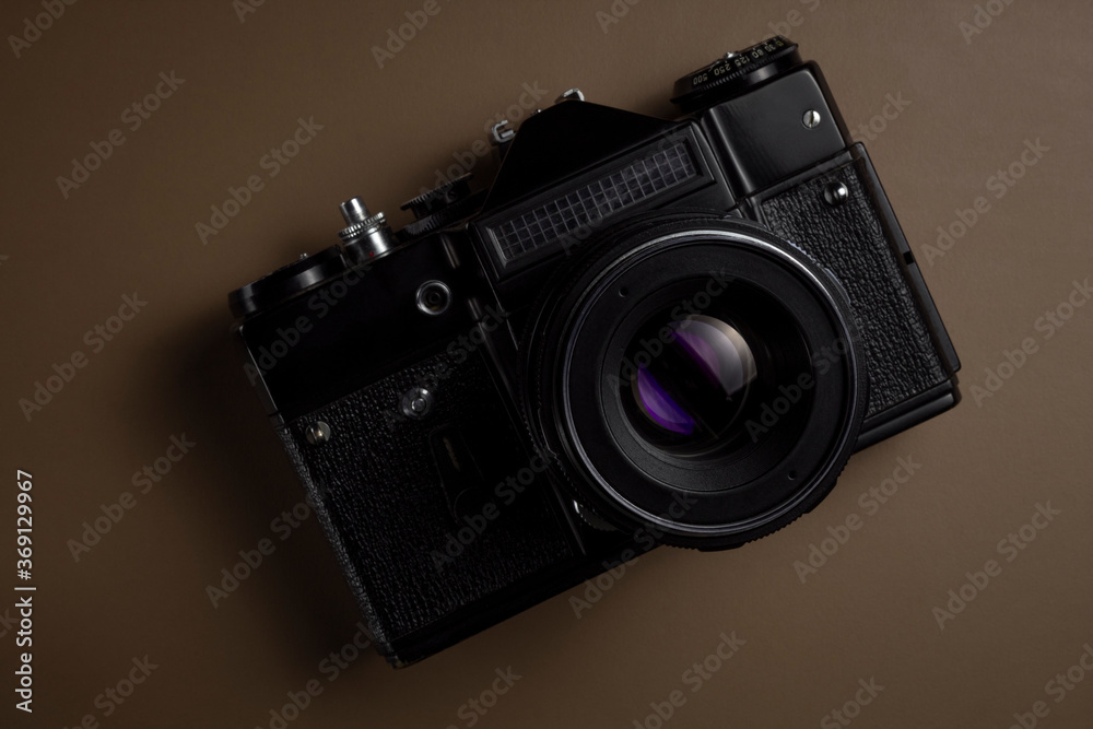 black vintage SLR camera on solid background, isolated