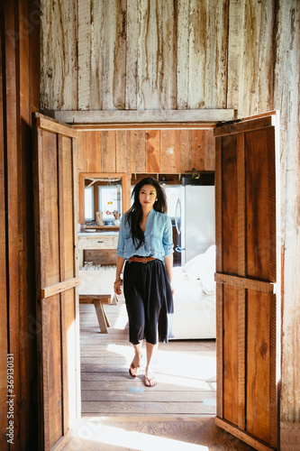 Asian Woman walking in farmhouse
