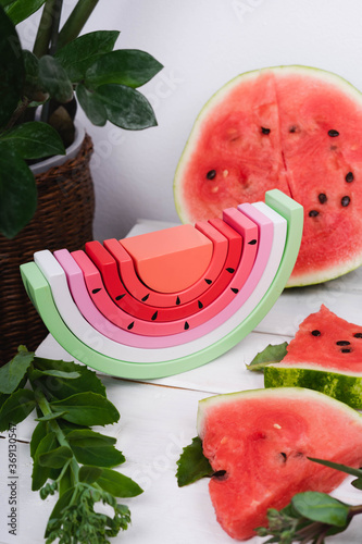 Toy rainbow made of natural wood for a small child. Wooden watermelon.
