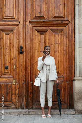 Wallpaper Mural Cheerful black female recording audio message near aged building Torontodigital.ca