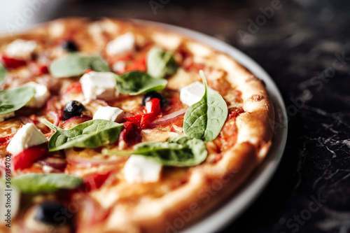 Pizza with with cheese, olives and herbs. Cafe, pizzeria and restaurant menu.