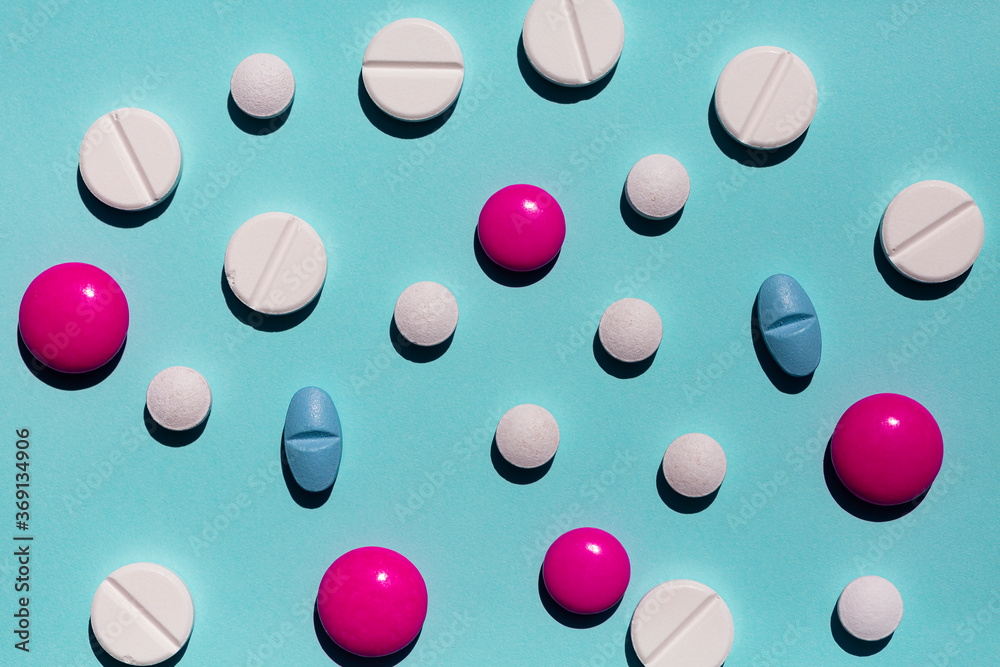Pills scattered on blue background Pills scattered on blue background