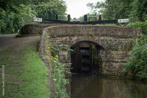 Stone bridge in front of the canal lock, Peak Forest Canal near Manchester. 