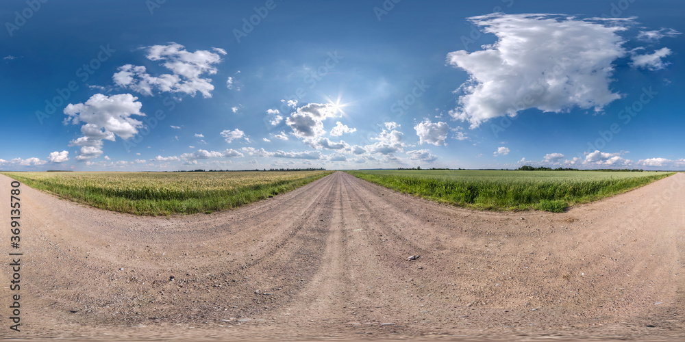 Fototapeta premium Full spherical seamless hdri panorama 360 degrees angle view on no traffic white sand gravel road among fields with clear sky with beautiful clouds in equirectangular projection, VR AR content