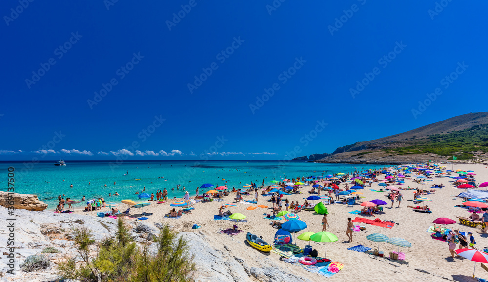 CALA MESQUIDA, MALLORCA, SPAIN - 19 July 2020: People enjoying beautiful sandy beach of on Mallorca, Mediterranean Sea, Spain.