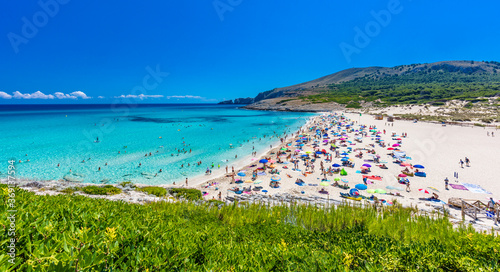 CALA MESQUIDA, MALLORCA, SPAIN - 19 July 2020: People enjoying beautiful sandy beach of on Mallorca, Mediterranean Sea, Spain.