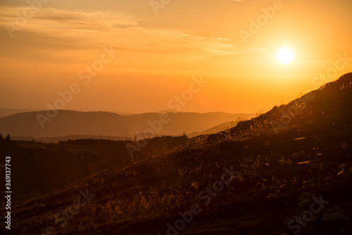 view of sunset on the mountain foreground without flare