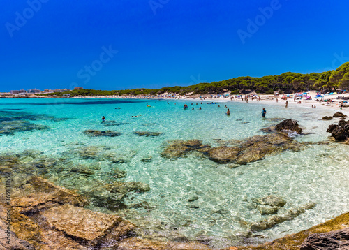 Fototapeta Naklejka Na Ścianę i Meble -  CALA AGULLA, MALLORCA, SPAIN - 21 July 2020: People enjoying summer on the popular beach on Mallorca,  Balearic Islands.