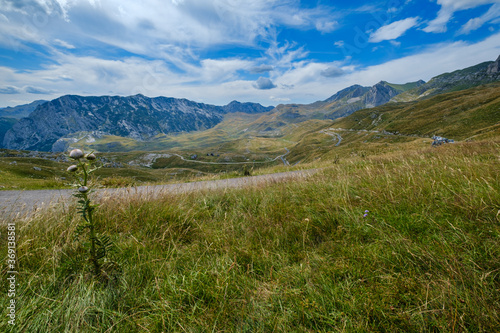 Picturesque summer mountain landscape of Durmitor National Park, Montenegro, Europe, Balkans Dinaric Alps, UNESCO World Heritage. Durmitor panoramic road, Sedlo pass. Car models unrecognizable.