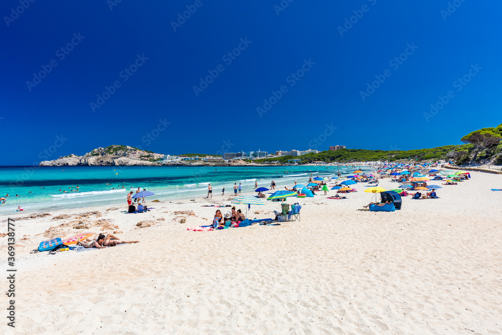 CALA AGULLA, MALLORCA, SPAIN - 21 July 2020: People enjoying summer on the popular beach on Mallorca,  Balearic Islands.