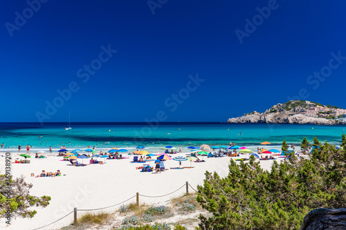 CALA AGULLA, MALLORCA, SPAIN - 21 July 2020: People enjoying summer on the popular beach on Mallorca, Balearic Islands.