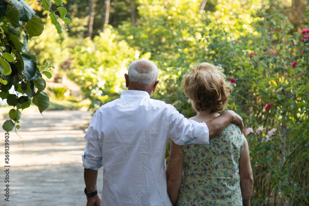 Fototapeta premium senior couple walking embraced outdoors