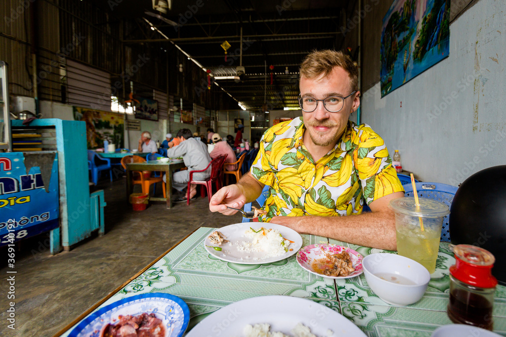 Handsome caucasian man in local vietnamese restaurant