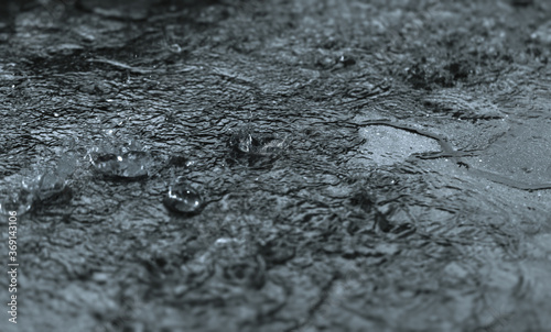 Rain drops splashing during hard rain fall at night.Selective focus and shallow depth of field.