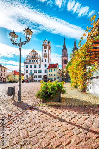 Splendid autumn cityscape of Oschatz central square with Stadtverwaltung and St. Aegidien church photo