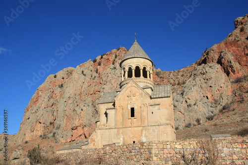 Beautiful Noravank armenian monastery and church, orange, with a colorful blue sky, in front of the mountain, Armenia.