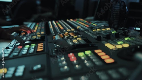 Broadcast Tv Studio Production - Vision Switcher Studio Director broadcast video mixer operation - Close-up of hand. Hands of a cinematographer who worked on the vision mixer, switch the TV panel.