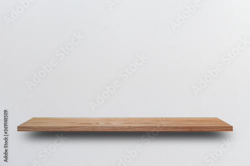 Front view empty wooden shelf and grey wall. Design concept