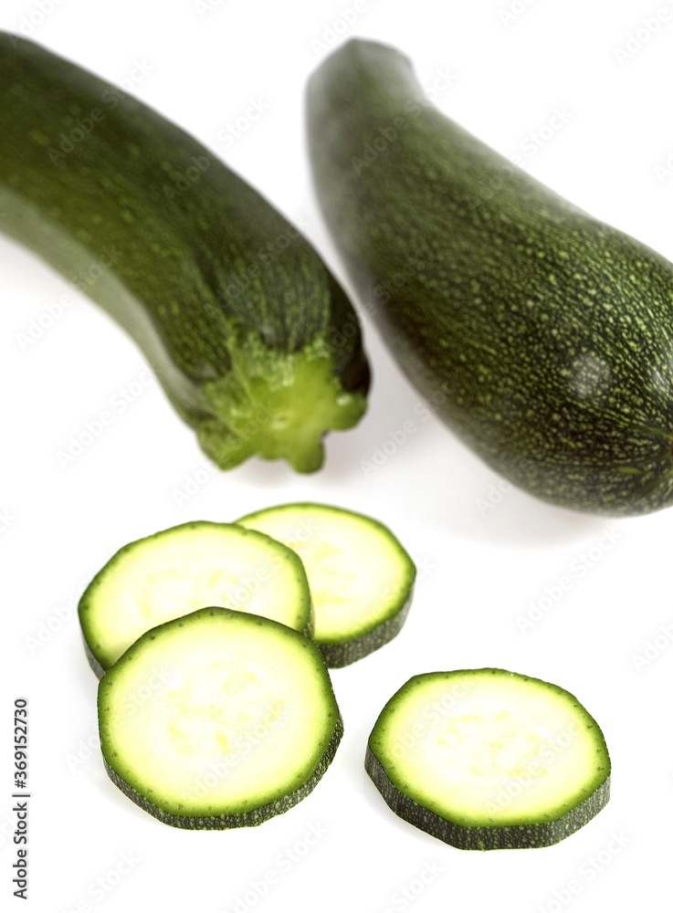 LONG COURGETTE OR ZUCCHINI AGAINST WHITE BACKGROUND LONG COURGETTE OR ZUCCHINI AGAINST WHITE BACKGROUND