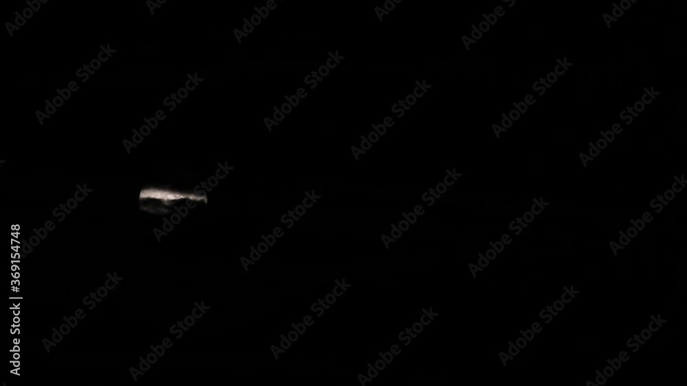 Slow motion moon shot, full moonrise in dark sky at night Slow motion moon shot, full moonrise in dark sky at night