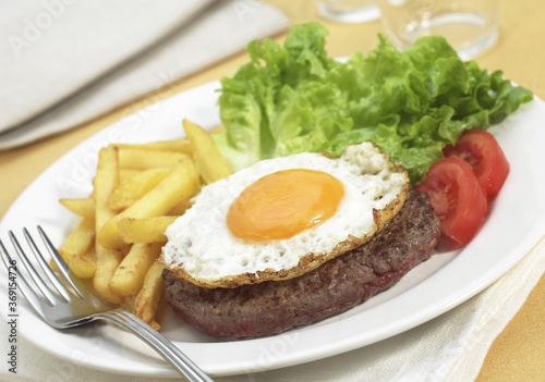 STEAK AND EGG WITH SALAD AND FRENCH FRIES