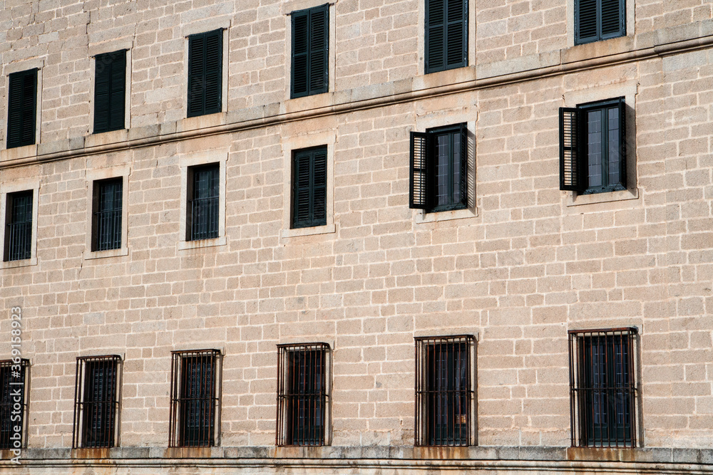 Architecture. Closeup of the the wall made of blocks and windows in the monastery Royal Site of San Lorenzo de El Escorial, Spain. 