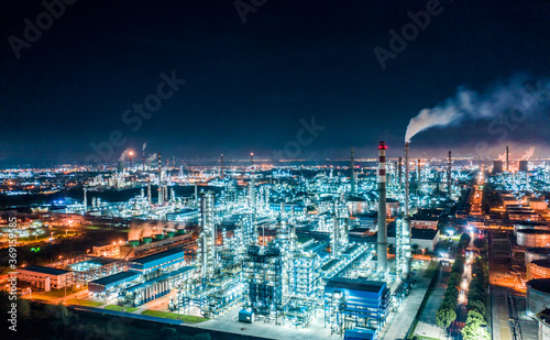 Aerial view oil and gas tank with oil refinery background at night
