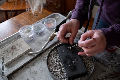 Woman making jewelry pendent