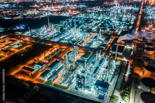 Aerial view oil and gas tank with oil refinery background at night photo