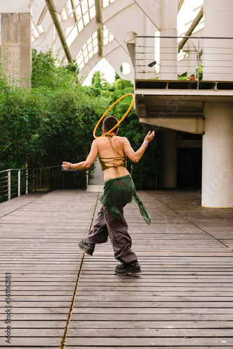 Hula hoop dancer walking in pavilion