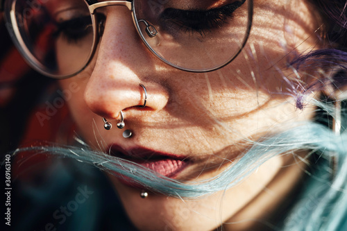 Alternative blue haired lady with glasses and piercing photo
