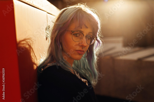 Beautiful blue haired lady with gasses and piercing photo