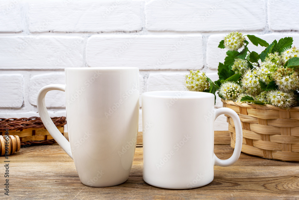 White coffee and cappuccino mug mockup with white spirea White coffee and cappuccino mug mockup with white spirea