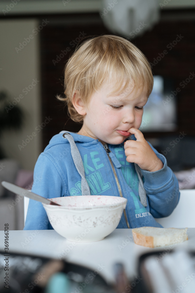 Cute toddler boy during breakfast at home Cute toddler boy during breakfast at home