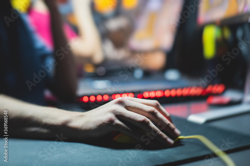 Cyber sport e-sports tournament  team of professional gamers  close-up on gamer s hands on a keyboard  pushing button  gamers playing in competitive moba strategy fps game on a cyber games arena club