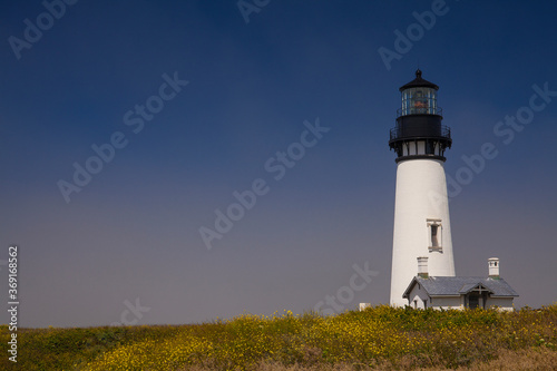 View of the Yaquina Head Lighthouse in Newport, Oregon, as fog starts to roll in 