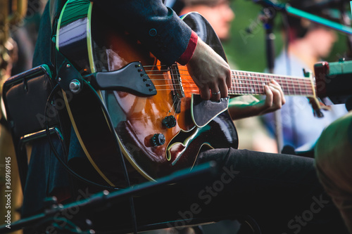 Photography Concert view of an electric acoustic guitar player with vocalist and musical jaz