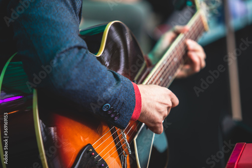 Photography Concert view of an electric acoustic guitar player with vocalist and musical jaz